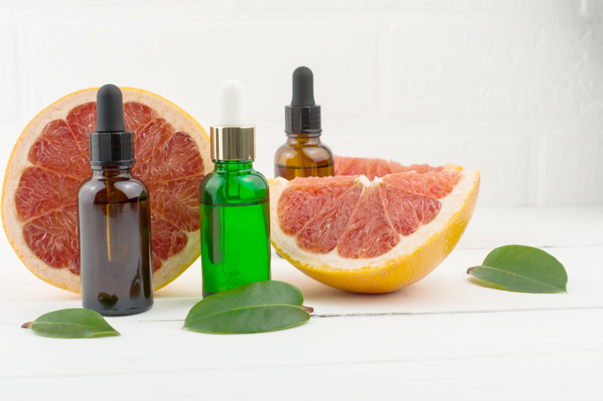 three cosmetic flaons with grapefruit oil for beauty, skin care, well-being. alternative medicine.